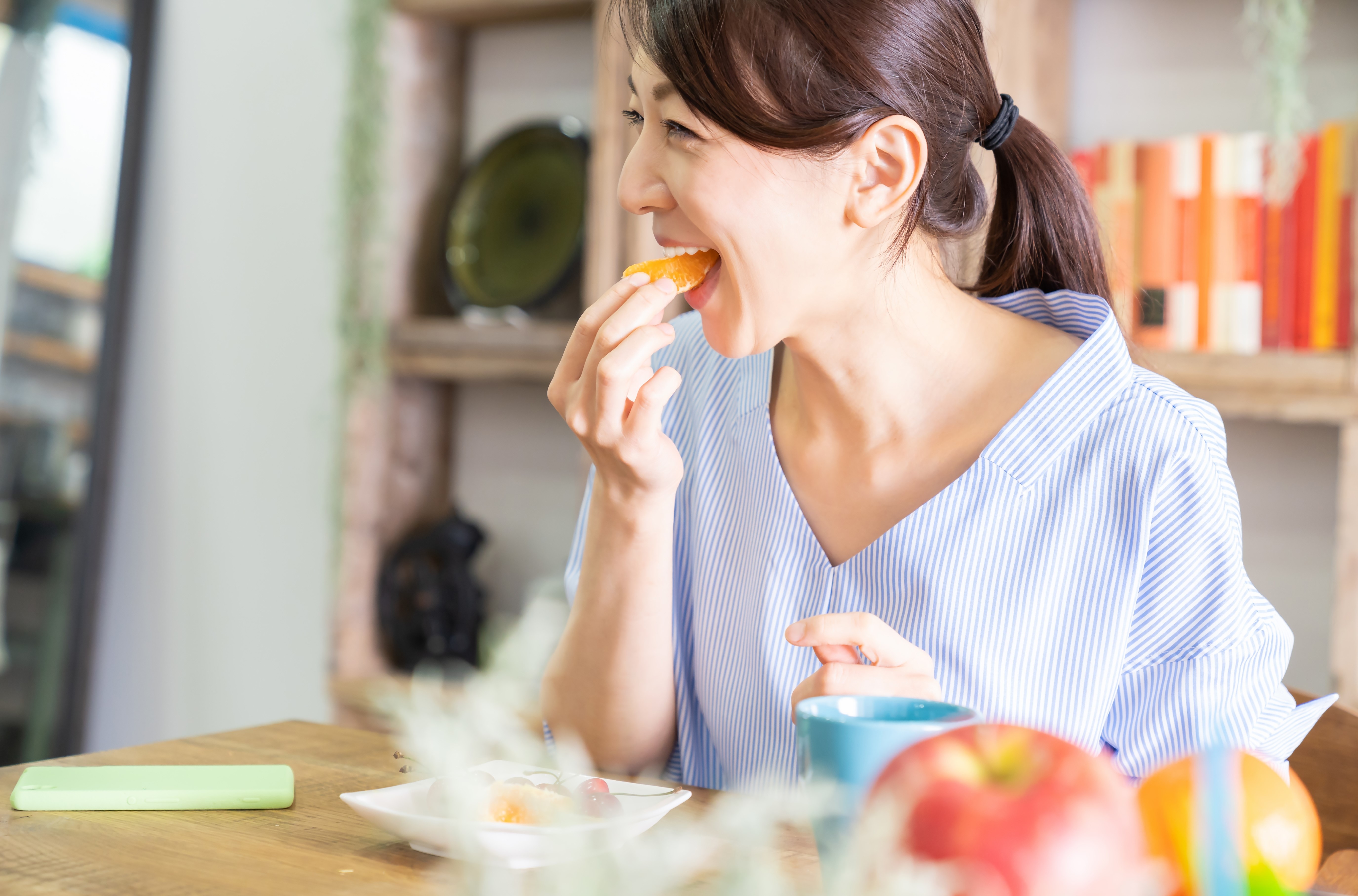 woman eating orange