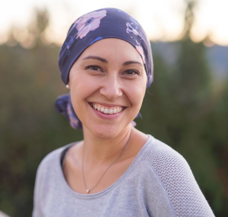 Woman smiling with head wrap on